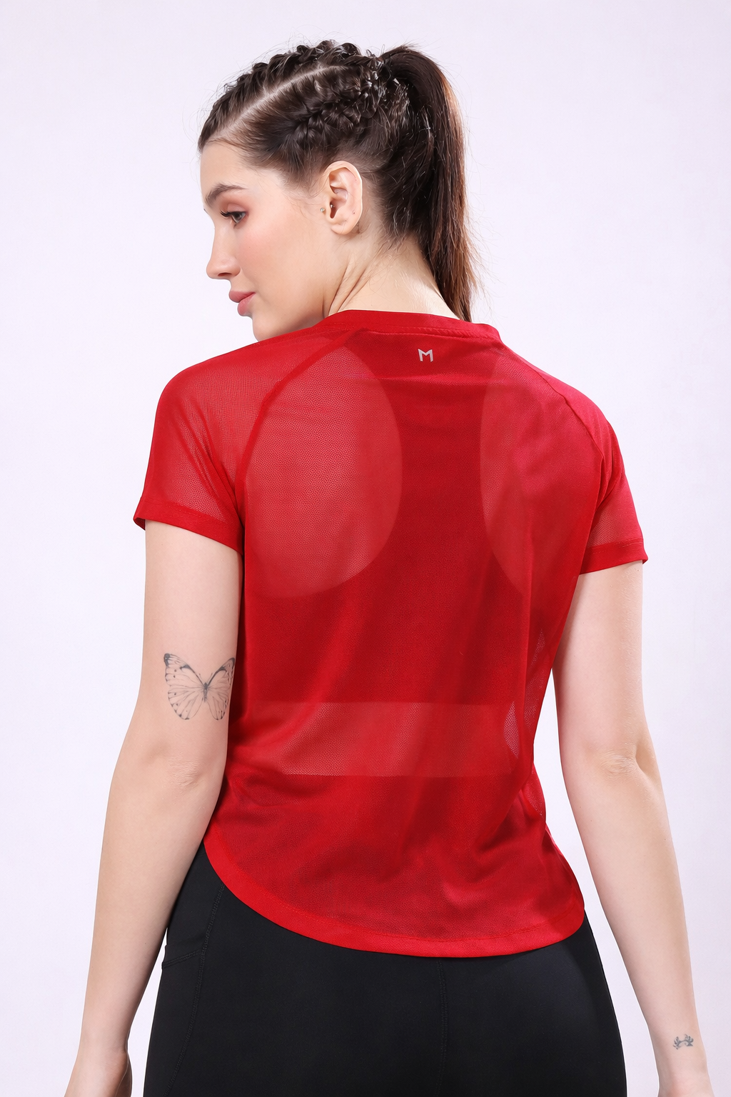 Woman wearing a red athletic shirt on a white background