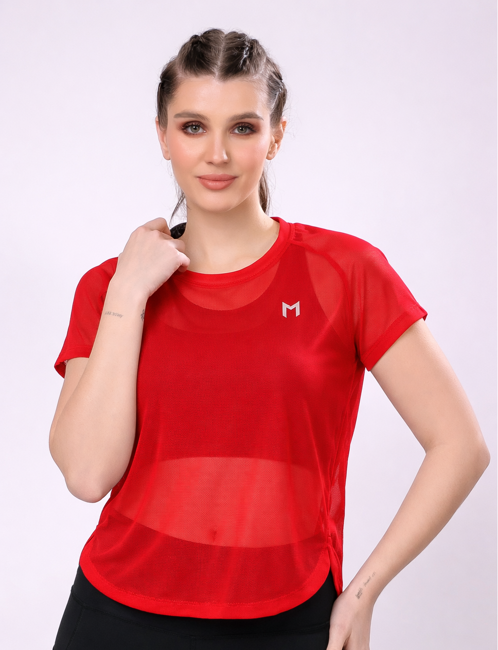 Woman wearing a red athletic shirt with a logo on a white background